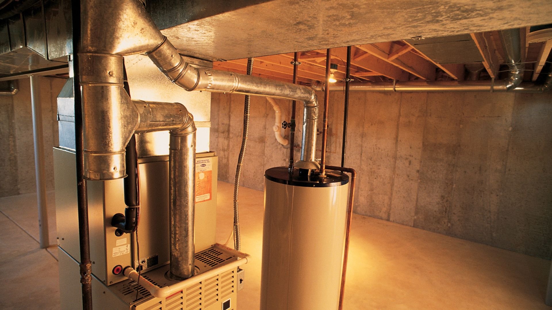 Water heater and furnace with metal pipes in a basement utility room