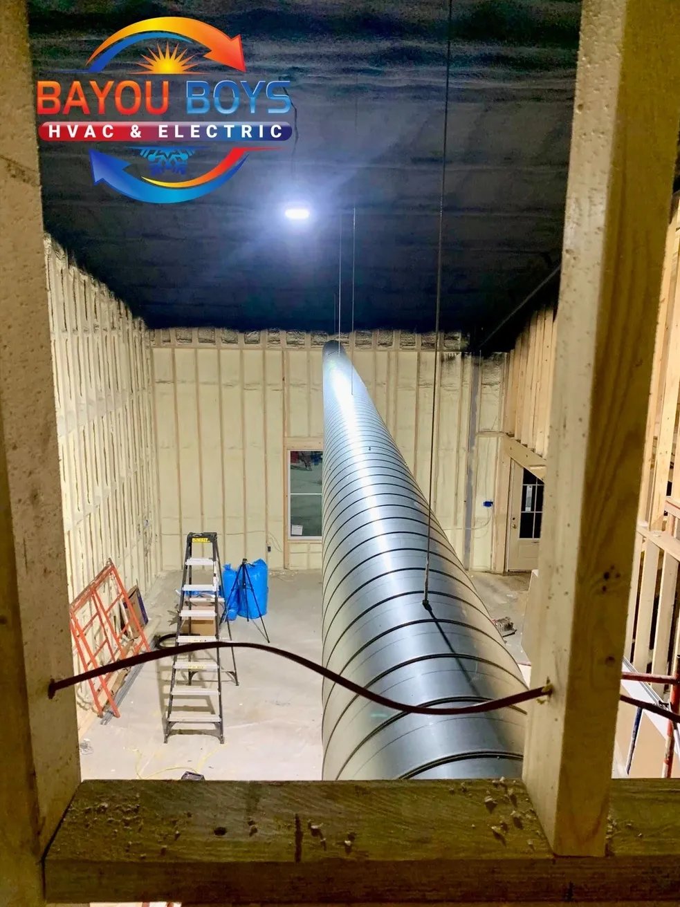 Large spiral duct installation in progress at Bayou Boys HVAC workspace