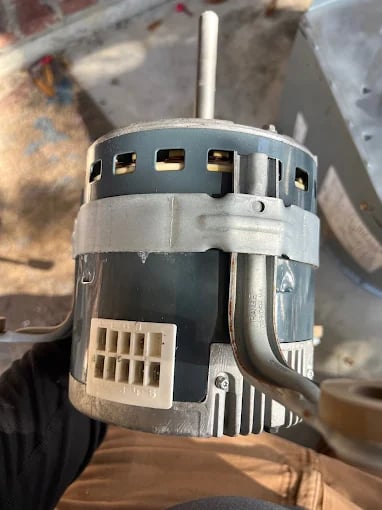 Electric motor with metal housing and ventilation slots, industrial machinery component