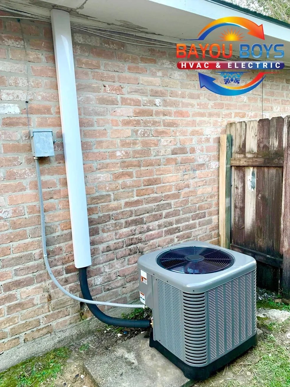 Bayou Boys HVAC air conditioning unit installed on brick wall exterior